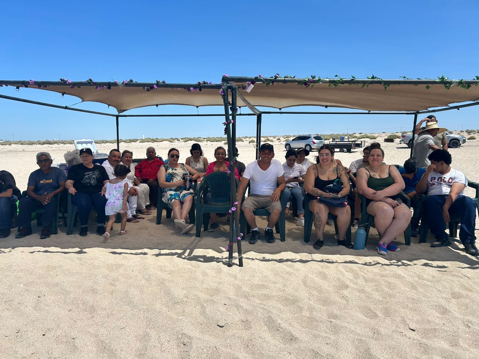 Church members gathered under a shade structure on the beach at Puerto Penasco, Mexico
