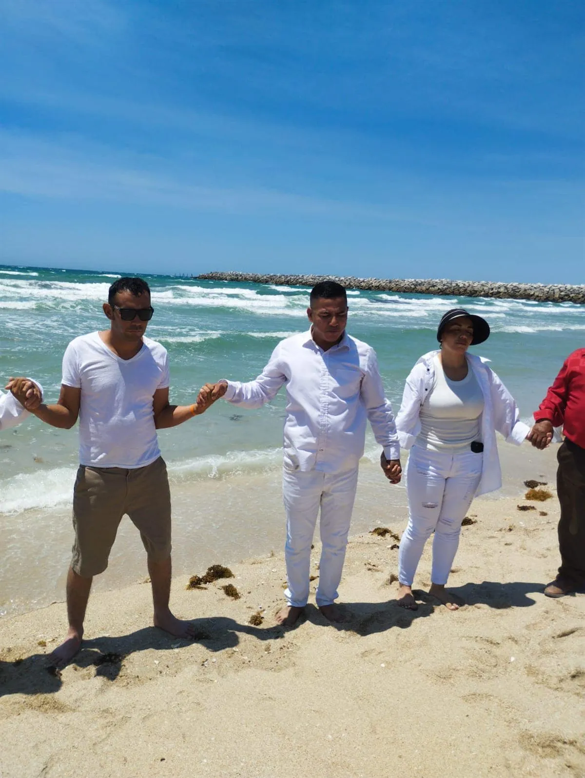 A prayer circle on the beach during youth camp with Faith Family Church Rocky Point