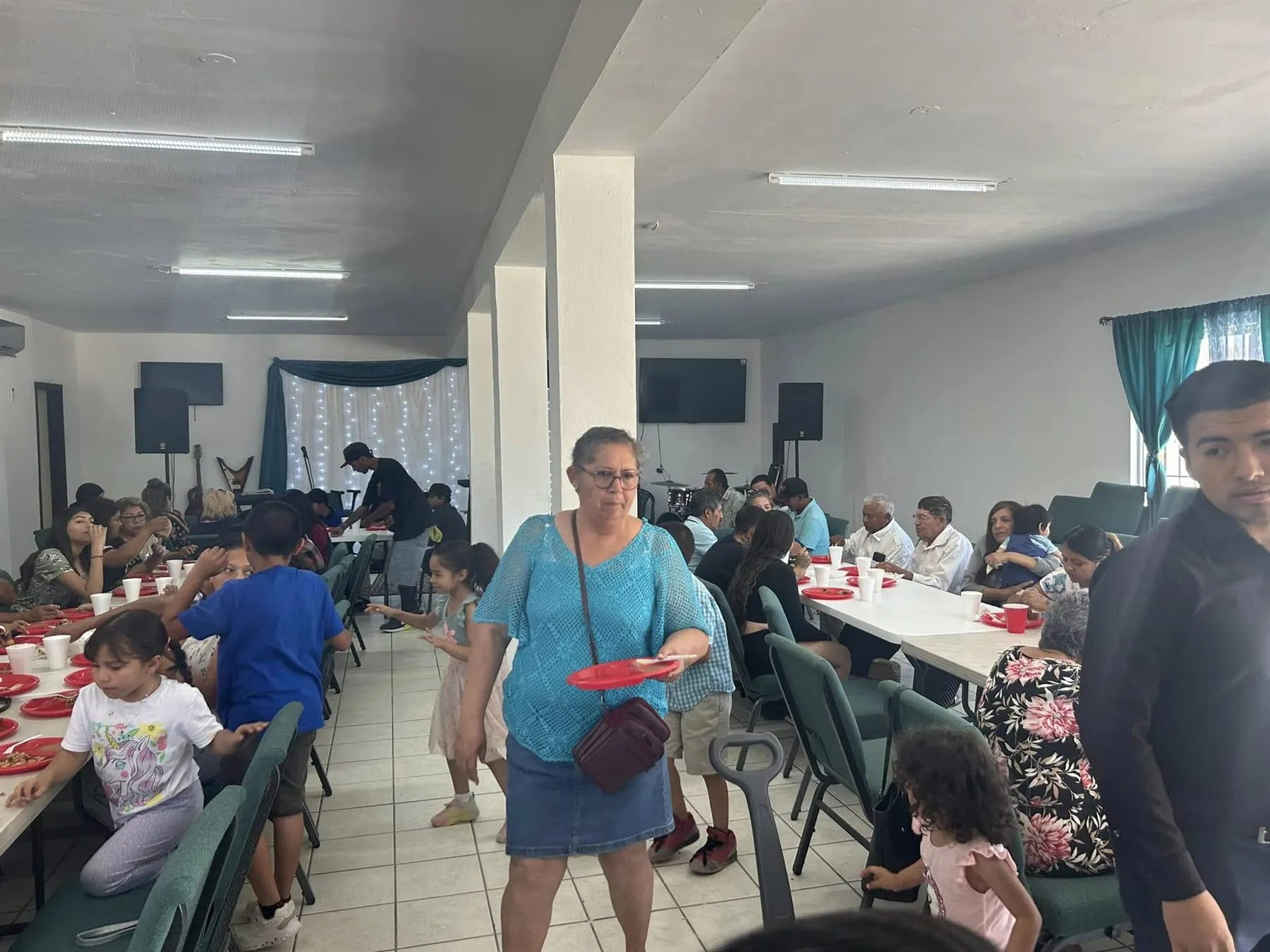 Families sharing a meal together in the fellowship hall at Faith Family Church Rocky Point