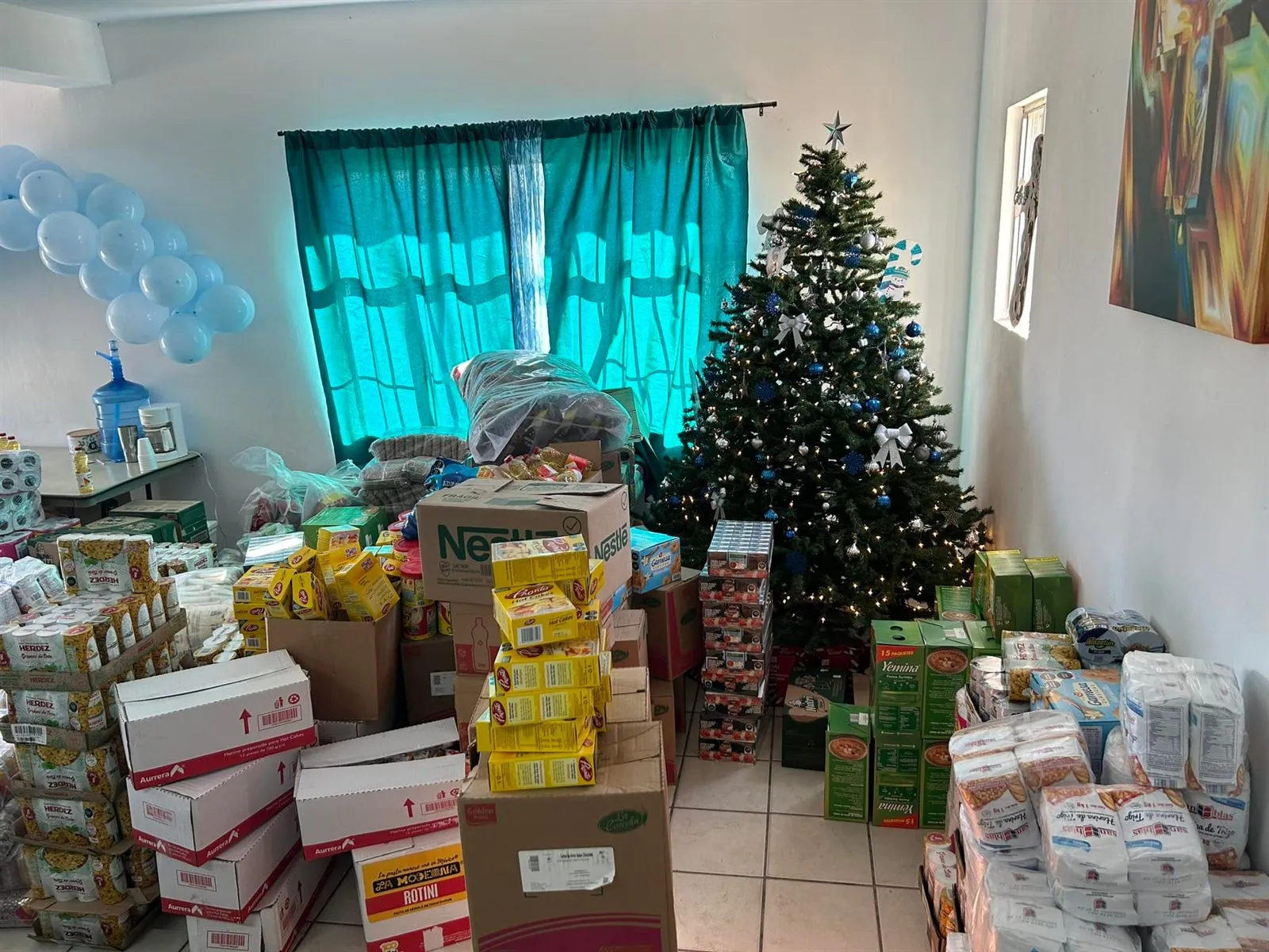 Donated flour, pasta, and staples stacked for distribution at Faith Family Church Rocky Point