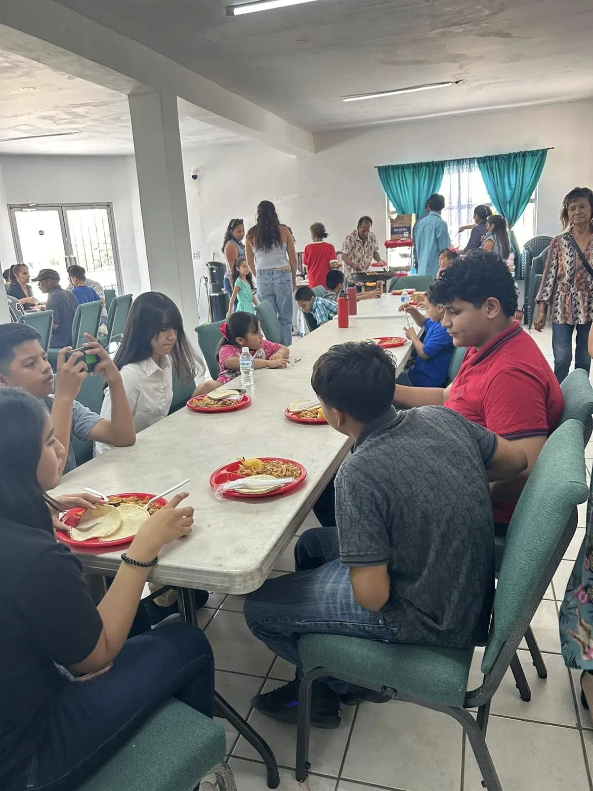 Children eating at long tables during a weekend breakfast at Faith Family Church Rocky Point