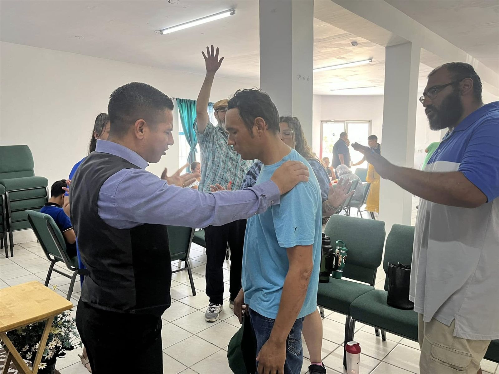 Pastor Antonio Juarez praying over a man during a service at Faith Family Church Rocky Point